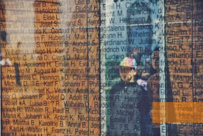 Image: Andernach, 1996, A visitor's reflection in the mirror with engraved names of victims, Paul Petzel